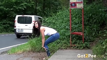 While waiting for her bus, this raven haired babe needs to pee so decides to relieve herself by the bus stop while smoking a cigarette at the same time in public!